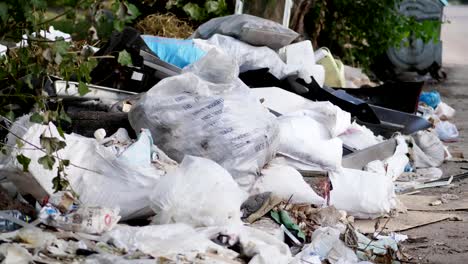 on-ground,-on-side-of-road,-lots-of-garbage-is-lying.-scattered-trash,-rubbish,-old-things,-car-tires,-broken-glass,-plastic.-garbage-dump.-ecology,-pollution-of-the-environment