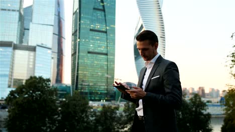 Young-caucasian-man-holding-smartphone-for-business-work.