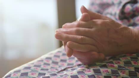 cinematic-hands-of-an-elderly-woman-who-pray-in-faith-in-the-name-of-our-lord