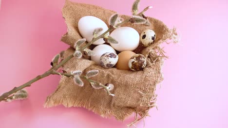 Easter-eggs-on-a-pink-background-with-a-sprig-of-willow