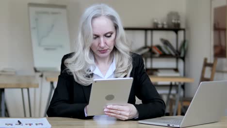 Old-Business-Woman-Using-Tablet