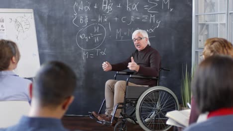 Mature-Professor-in-Wheelchair-Talking-to-Students