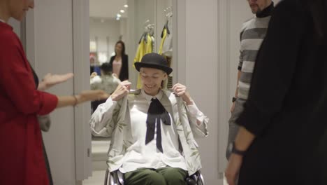 Woman-in-Wheelchair-Trying-on-Cardigan-at-Clothing-Store