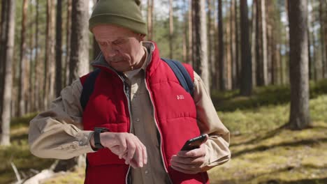 Sportlicher-Senior-mit-Gadgets-in-Woods