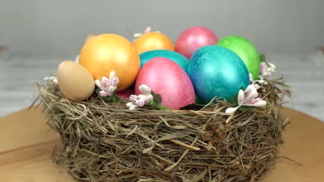 Rotating-beautiful-nest-with-colorful-Easter-eggs,-background,-Easter-holiday,-religion,-close-up