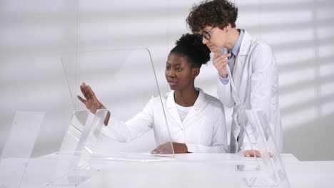 Black-Female-Researcher-Demonstrating-Computer-Model-on-Futuristic-Screen