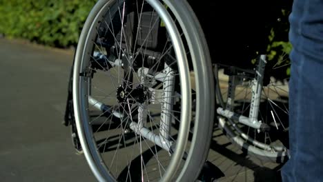 Tracking-shot-of-a-wheelchair-in-the-park