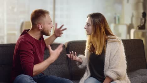 Young-couple-having-harsh-controversies-on-a-couch