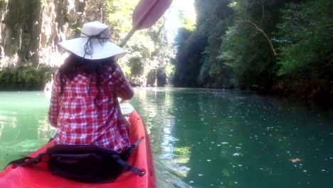 Woman-Exploring-Beautiful-Lagoon-On-Kayak-Boat-Action-Camera-POV-Of-Girl-Paddling