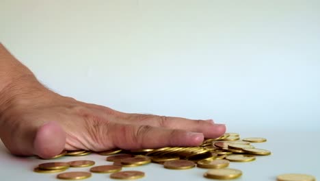 Hand-smash-on-stack-of-gold-coin-on-white-background,-4k,-UHD.