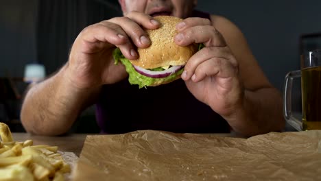 Obese-man-taking-big-burger-but-not-biting-it,-refusal-from-bad-eating-habits