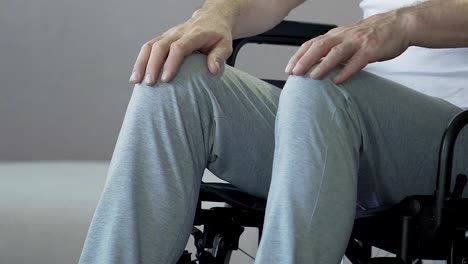 Feet-of-paralyzed-male-sitting-in-wheelchair-socially-vulnerable-disabled-person