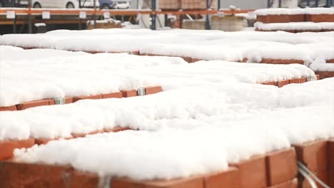 Stack-of-orange-clay-brick-with-snow