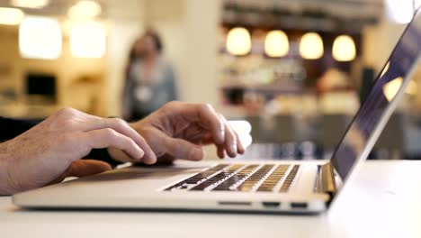 Man's-Hands-Working-on-Laptop-Analyzes-Charts-and-Graphs-and-Fingers-Typing-Key