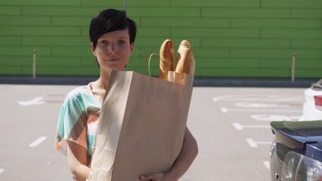 Girl-with-purchases-messaging-after-left-grocery-store