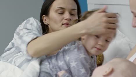 Children-Relaxing-in-Bed-with-Mothers