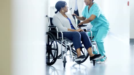 Multi-ethnic-team-with-senior-patient-in-wheelchair