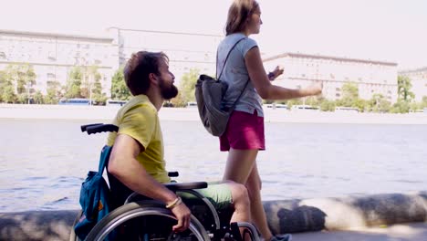 Young-disable-man-on-a-walk-near-the-river-with-his-wife