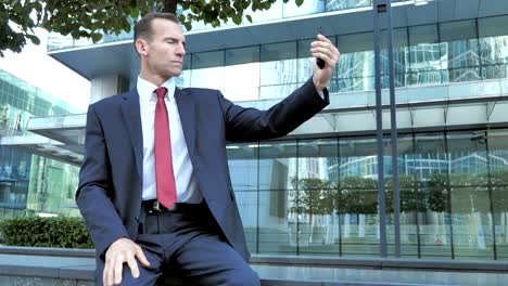 Businessman-Taking-Selfie-on-Phone