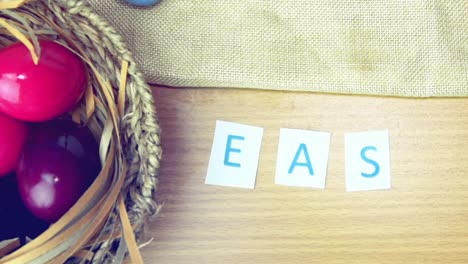 Happy-Easter-on-table-decorated-with-easter-eggs.