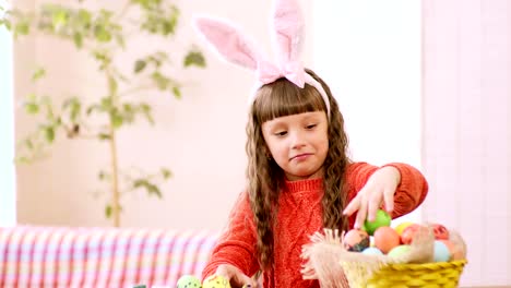 the-girl-considers-Easter-eggs-in-the-basket.