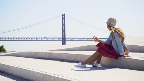 Woman-with-phone-on-seafront