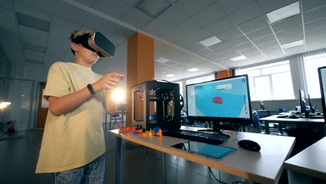 Excited-school-kid-examining-3D-technology-with-virtual-reality-glasses-in-three-dimensional-printing-laboratory.-4K.