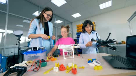 Los-niños-de-la-escuela-joven-en-el-laboratorio-de-investigación-estudian-tecnologías-aéreas-drones,-Copters,-aeronaves.