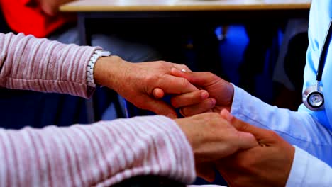 Mid-section-of-female-doctor-consoling-sad-disabled-senior-woman-at-nursing-home-4k