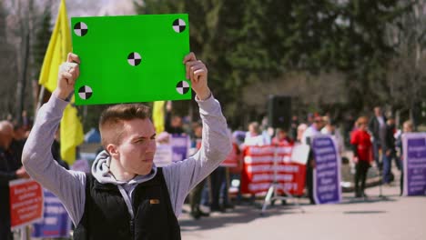 Man-on-demonstration-standing-hold-track-points-chroma-key-billboard.-Angry-4k.