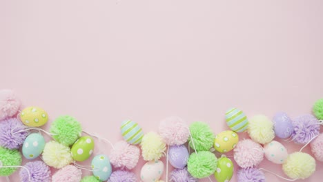 Pastel-color-pom-poms-on-a-pink-background.