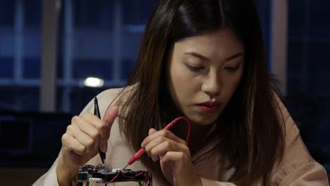 Female-electronics-engineer-working-with-robot-project-at-lab.-Technology-and-innovation-concept.