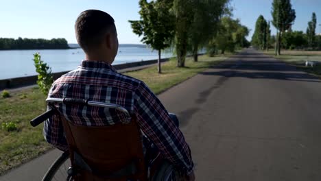 A-man-in-a-wheelchair-walks-on-the-waterfront