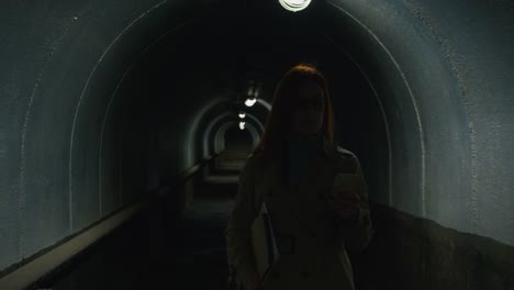 Smiling-woman-ringing-on-the-phone-in-tunnel