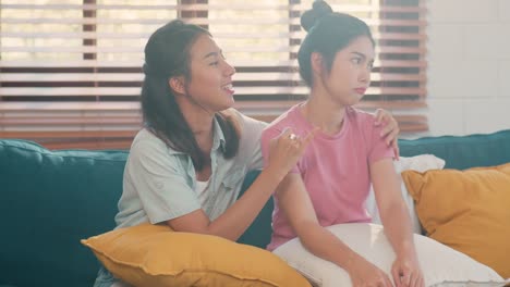 Young-Asian-Lesbian-couple-angry,-conflict,-sad-flight-annoyed-on-sofa-in-living-room-at-home.