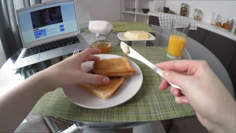 POV-of-Woman-Having-Breakfast-and-Watching-Series-on-Laptop