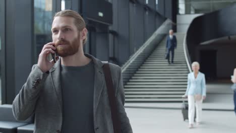 Ginger-Man-Having-Phone-Conversation-in-Airport