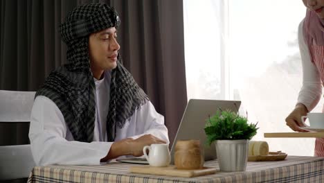 Asian-Muslim-Man-Enjoying-A-Relaxing-Moment-in-the-Coffeeshop