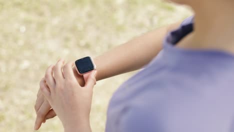 Close-up-athlete-checking-fitness-progress-on-her-smart-watch-after-running-workout.