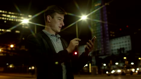 Young-happy-man-is-chatting-with-someone-and-laughing