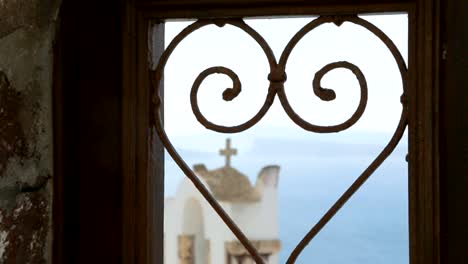 Hammered-heart-in-window-frame-with-old-church-cross-behind,-love-and-marriage