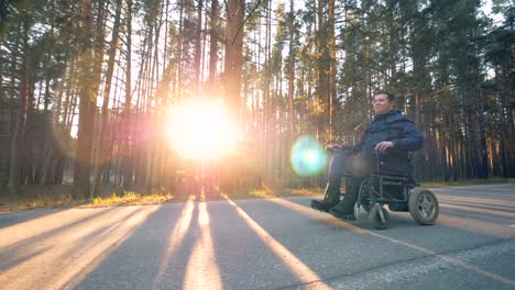 Moving-process-of-a-handicapped-person-in-a-wheelchair-outdoors