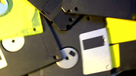 pile-of-old-style-data-transfer-floppy-discs,-rotating-spinning-background