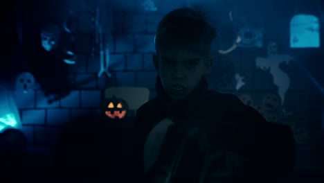 Young-boy-in-a-vampire-costume-for-Halloween-showing-his-scary-face-and-teeth-to-camera