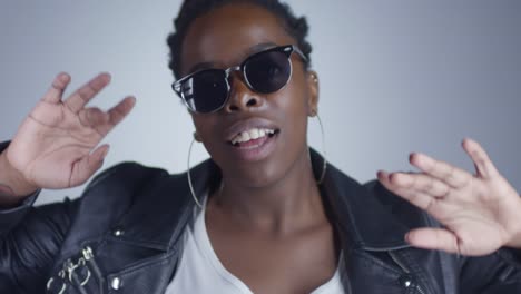 Confident-Black-Woman-in-Sunglasses-Dancing-before-Camera