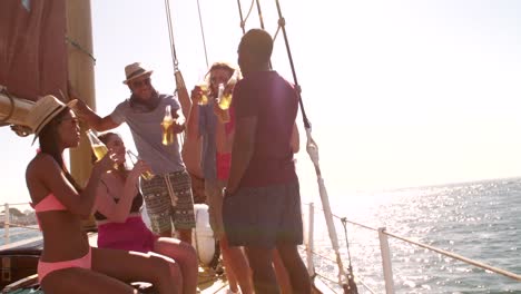 Group-of-laughing-mixed-race-friends-drinking-on-a-yacht