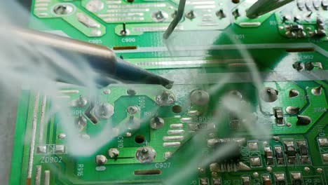 hand-of-technical-Electronics-Soldering-a-computer-circuit-board