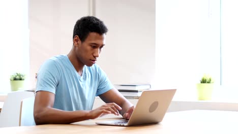 Young-Black-Man-Working-On-Laptop