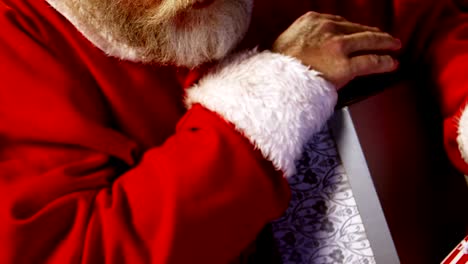 Santa-claus-removing-gift-boxes-from-sack