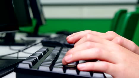 Schoolboy-studying-on-computer-in-classroom